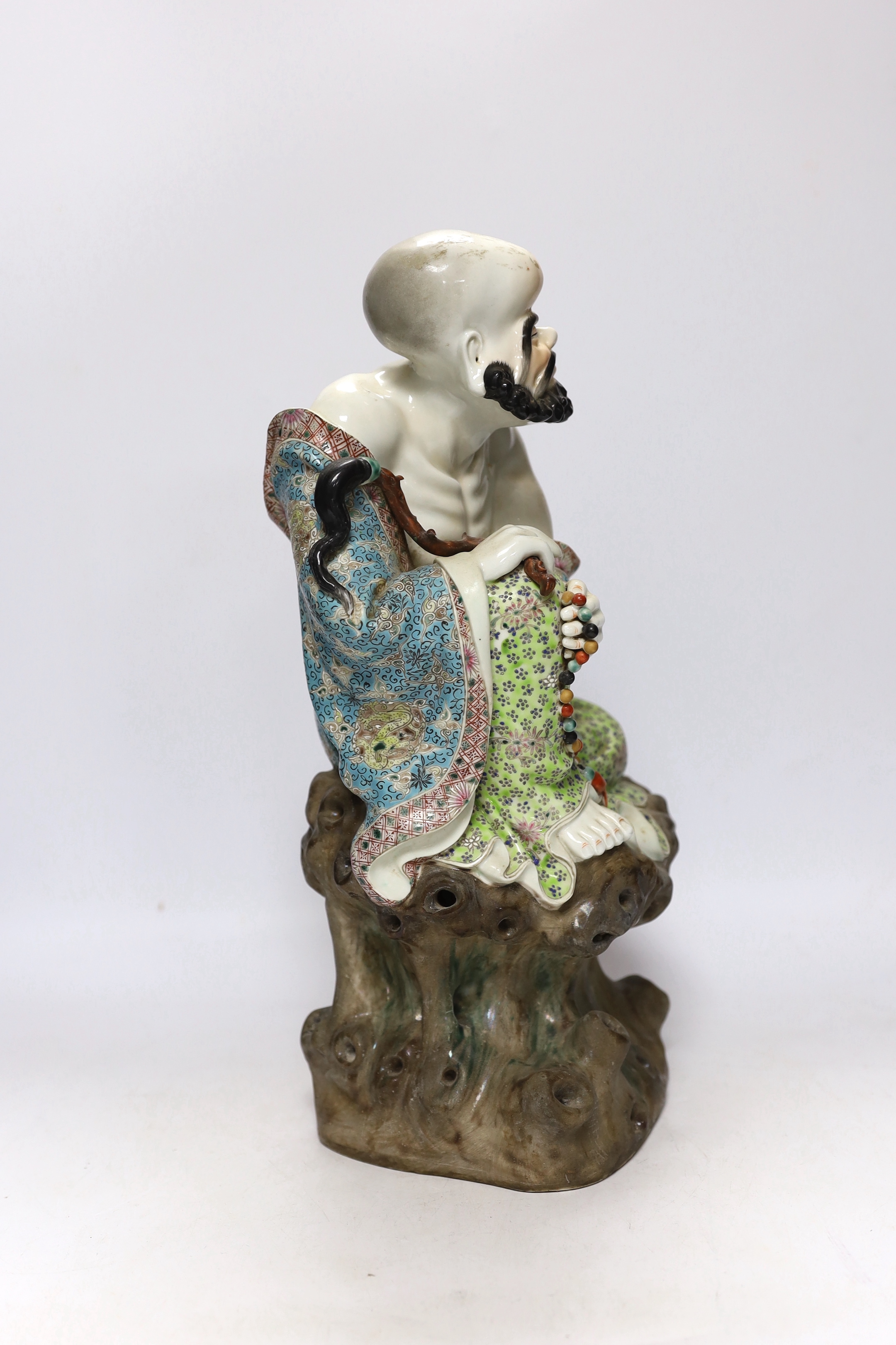 A Chinese enamelled porcelain figure of a luohan, 38cm high